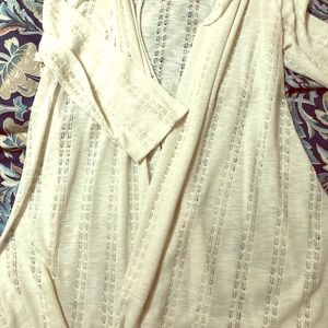 Short cream colored cardigan.